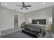 Comfortable main bedroom featuring a ceiling fan, ensuite bathroom, and neutral colors at 15155 Mayberry Dr, Winter Garden, FL 34787
