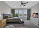 Bright main bedroom with a ceiling fan, ample natural light, and lake views at 15155 Mayberry Dr, Winter Garden, FL 34787