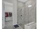 Elegant walk-in shower featuring glass doors and marble tile surround at 15155 Mayberry Dr, Winter Garden, FL 34787