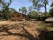 A single-story home surrounded by large trees and a spacious yard at 19942 Se 155Th Pl, Umatilla, FL 32784