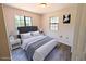 Comfortable bedroom with a cozy bed, natural light, and a stylish gray headboard at 19942 Se 155Th Pl, Umatilla, FL 32784