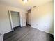 This bedroom features light gray wood-style floors, a closet, and multiple electrical outlets at 19942 Se 155Th Pl, Umatilla, FL 32784
