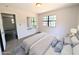 Cozy bedroom with a large window, a mirror, and a comfortable bed with soft pillows at 19942 Se 155Th Pl, Umatilla, FL 32784