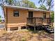 Exterior view featuring a wooden deck, wood siding, windows and updated electrical and HVAC systems at 19942 Se 155Th Pl, Umatilla, FL 32784