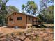 Cozy home featuring a wooden deck and exterior with a well maintained yard at 19942 Se 155Th Pl, Umatilla, FL 32784