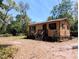 Charming home exterior with a well-maintained lawn and mature landscaping, perfect for comfortable living at 19942 Se 155Th Pl, Umatilla, FL 32784