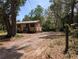 Exterior view of the house with a driveway, showcasing its curb appeal and inviting facade at 19942 Se 155Th Pl, Umatilla, FL 32784