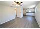Open-concept space with wood floors, neutral walls, white cabinets, and ample room for entertaining at 19942 Se 155Th Pl, Umatilla, FL 32784