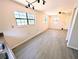 Open-concept living room showcasing wood floors, neutral walls, bright windows, and ample space at 19942 Se 155Th Pl, Umatilla, FL 32784