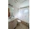 Clean bathroom with single sink vanity, toilet and bathtub shower combo at 2708 Sedgefield Avenue, Deltona, FL 32725