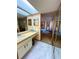 Clean bathroom with vanity, large mirror and access to bedroom at 2708 Sedgefield Avenue, Deltona, FL 32725