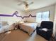 Bedroom with double bed, ceiling fan and armchair at 2708 Sedgefield Avenue, Deltona, FL 32725