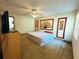 Bright bedroom featuring a king-size bed and ceiling fan at 2708 Sedgefield Avenue, Deltona, FL 32725