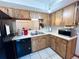 Galley kitchen with wood cabinets and modern appliances at 2708 Sedgefield Avenue, Deltona, FL 32725