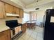 Kitchen area with wood cabinets and stainless steel appliances at 2708 Sedgefield Avenue, Deltona, FL 32725