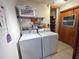 Laundry room with washer, dryer, and storage shelving at 2708 Sedgefield Avenue, Deltona, FL 32725