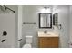 Cozy bathroom with white toilet, cream colored sink, dark hardware, and shower at 2829 Shelburne Way, St Cloud, FL 34772