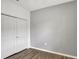 Bedroom features a closet, light gray walls, and wood-look flooring at 2829 Shelburne Way, St Cloud, FL 34772