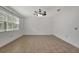 Spacious bedroom with neutral tile flooring, a ceiling fan, and a bright window at 2829 Shelburne Way, St Cloud, FL 34772