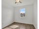 Bright bedroom with wood-look floors, ceiling fan and a sunny window at 2829 Shelburne Way, St Cloud, FL 34772