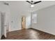 Bright bedroom with wood-look floors and access to a bathroom and closet at 2829 Shelburne Way, St Cloud, FL 34772