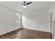 Bright bedroom features wood-look floors, ceiling fan, and a sunny window at 2829 Shelburne Way, St Cloud, FL 34772