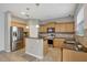 Modern kitchen featuring stainless steel appliances, a kitchen island, and wooden cabinets at 2829 Shelburne Way, St Cloud, FL 34772