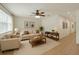 Bright living room featuring neutral tones, ceiling fan, and elegant furniture arrangement at 2829 Shelburne Way, St Cloud, FL 34772