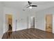 Large main bedroom with wood-look flooring, ceiling fan, and ensuite bathroom at 2829 Shelburne Way, St Cloud, FL 34772