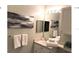 Clean bathroom with vanity and large mirror at 8817 Dunes Ct # 203, Kissimmee, FL 34747