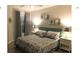 Main bedroom with king-size bed and nightstands at 8817 Dunes Ct # 203, Kissimmee, FL 34747