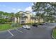 Condo building with parking lot and landscaping at 8817 Dunes Ct # 203, Kissimmee, FL 34747