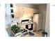 Well-equipped kitchen with light cabinets and appliances at 8817 Dunes Ct # 203, Kissimmee, FL 34747
