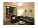 Spacious living room with sectional sofa and balcony access at 8817 Dunes Ct # 203, Kissimmee, FL 34747