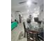 Bright dining room with glass table, chairs and wood-look floors at 1009 Fort Smith Blvd, Deltona, FL 32725