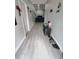 Long hallway with wood-look floors leading to the living area at 1009 Fort Smith Blvd, Deltona, FL 32725
