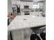 Kitchen island with white cabinets and a quartz countertop at 1009 Fort Smith Blvd, Deltona, FL 32725