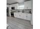 Modern kitchen with white cabinets, granite countertops and stainless steel appliances at 1009 Fort Smith Blvd, Deltona, FL 32725