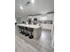 Modern kitchen with large island, white cabinets and granite countertops at 1009 Fort Smith Blvd, Deltona, FL 32725