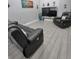 Relaxing living room with two leather recliners and wood-look floors at 1009 Fort Smith Blvd, Deltona, FL 32725
