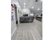 Spacious living room with gray sectional sofa and wood-look floors at 1009 Fort Smith Blvd, Deltona, FL 32725