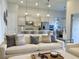 Open living room with modern furniture, an adjacent kitchen, and lots of light at 11637 Meadow Grove Cir, Orlando, FL 32836