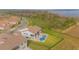 Aerial shot of a luxurious two-story home with a pool, manicured lawn, and expansive backyard with lake views at 13779 Abberwick Dr, Orlando, FL 32832