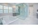 Luxurious bathroom with a modern tub, glass shower, and double-sink vanity at 13779 Abberwick Dr, Orlando, FL 32832