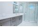 Bright bathroom featuring a marble-tiled shower and modern vanity with neutral gray decor at 13779 Abberwick Dr, Orlando, FL 32832