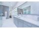 Stylish bathroom featuring a sleek vanity, a large mirror, and a walk-in shower at 13779 Abberwick Dr, Orlando, FL 32832