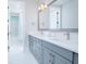 Bathroom featuring double vanity, modern fixtures, and a shower/tub combo with marble tile surround at 13779 Abberwick Dr, Orlando, FL 32832