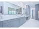 Contemporary bathroom with double vanities, ample storage, and marble countertops at 13779 Abberwick Dr, Orlando, FL 32832