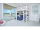 Bedroom with loft bed, desk area, and sliding glass doors to a patio with views at 13779 Abberwick Dr, Orlando, FL 32832