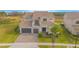 Beautiful two-story home with a two car garage, brick driveway, balcony, and well-manicured lawn at 13779 Abberwick Dr, Orlando, FL 32832